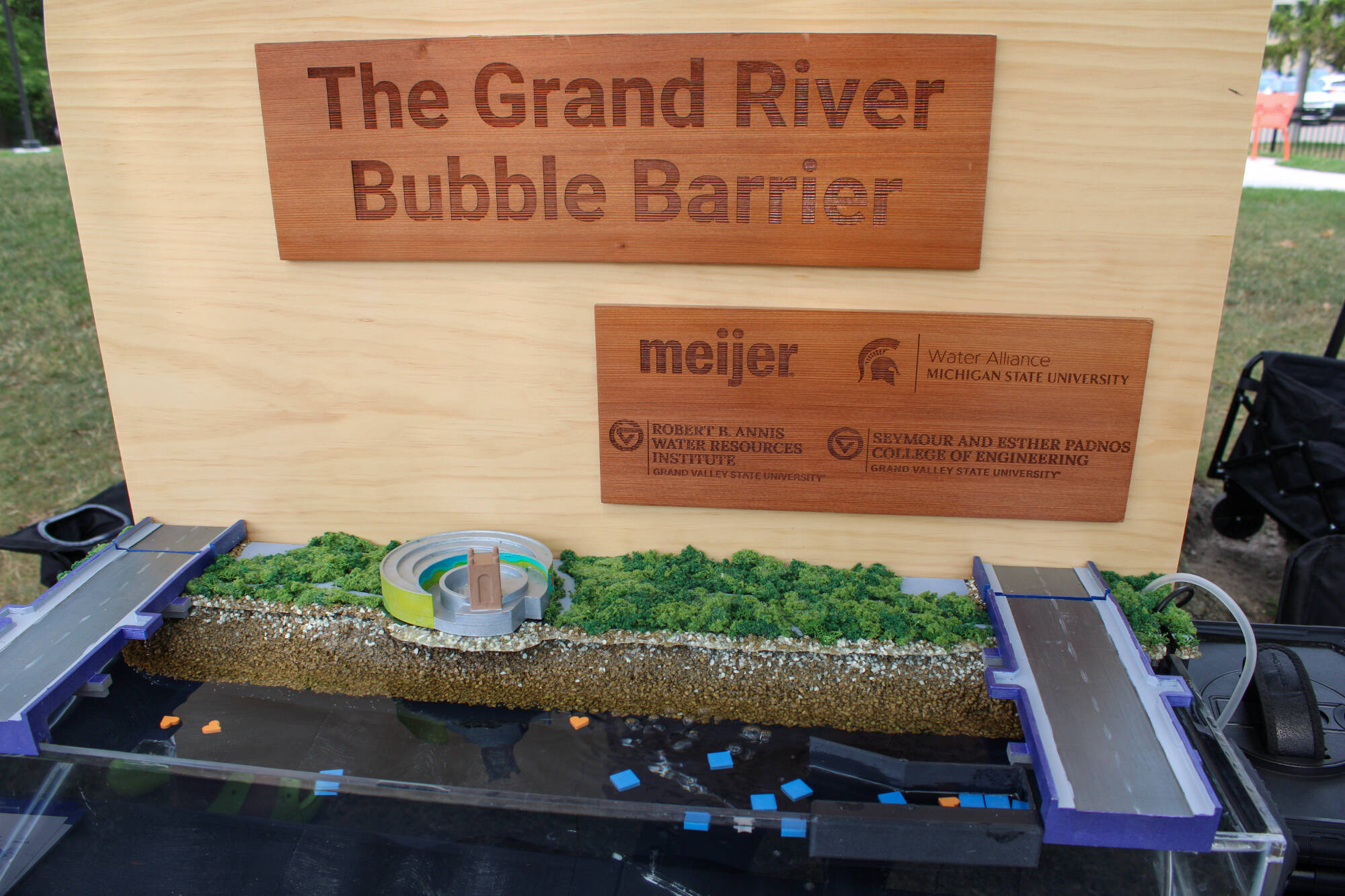 A tabletop replica of the Bubble Barrier being used for community engagement at Brenke Fish Ladder Park in Lansing, Michigan.